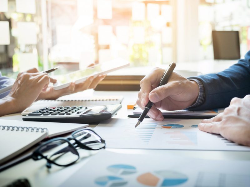 business man financial inspector and secretary making report, ca business man financial inspector and secretary making report, calculating or checking balance. Internal Revenue Service inspector checking document. Audit concept